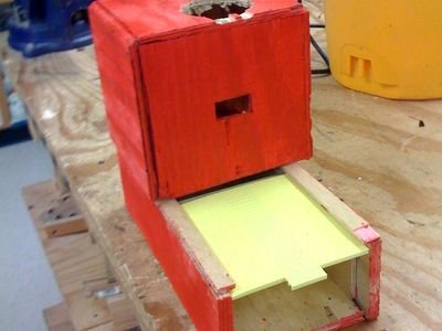 A simple timed pet food dispenser on a workbench (item type photo, not the exact product)